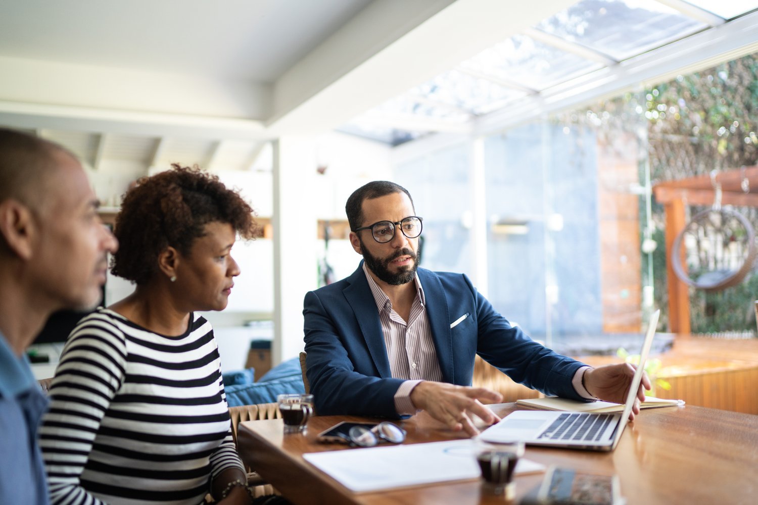 Couple talking to finance advisor at home Couple talking to finance advisor at home